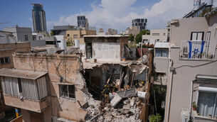 Israeli Home Front Command officers inspect an apartment building struck by an Iranian missile in Tel Aviv, Israel on Sunday (Maya Levin/AP) Israeli Home Front Command officers inspect an apartment building struck by an Iranian missile in Tel Aviv, Israel on Sunday (Maya Levin/AP)
