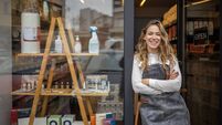 Proud female small business owner in front of the store