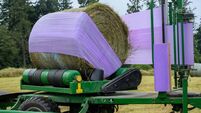 Silage being prepared in a round bale wrapper