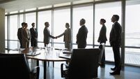 Business people shaking hands in conference room