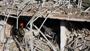 <p>An Israeli rescue officer at the site of an Iranian missile strike in Tel Aviv (Ohad Zwigenberg/AP)</p>