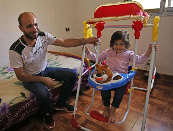 Abdul with Reem, 4 (Hussein Malla/AP) Abdul with Reem, 4 (Hussein Malla/AP)