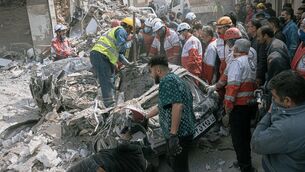 <p>First responders inspect a destroyed car at the site of a residential building hit in an overnight strike during the U.S.-Israeli military campaign in Tabriz, East Azerbaijan Province. Picture: AP Photo/Matin Hashemi.</p>