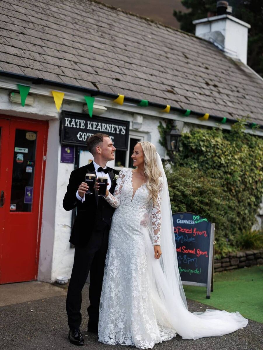 Kiara Carolan and Kealen Conboy share a drink below Kerry-Mayo colours