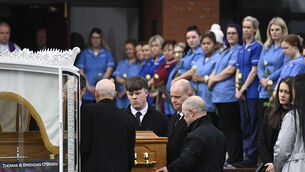 <p>Family and friends watch as the coffin is carried in to Holy Family Church (Mark Marlow/PA)</p>