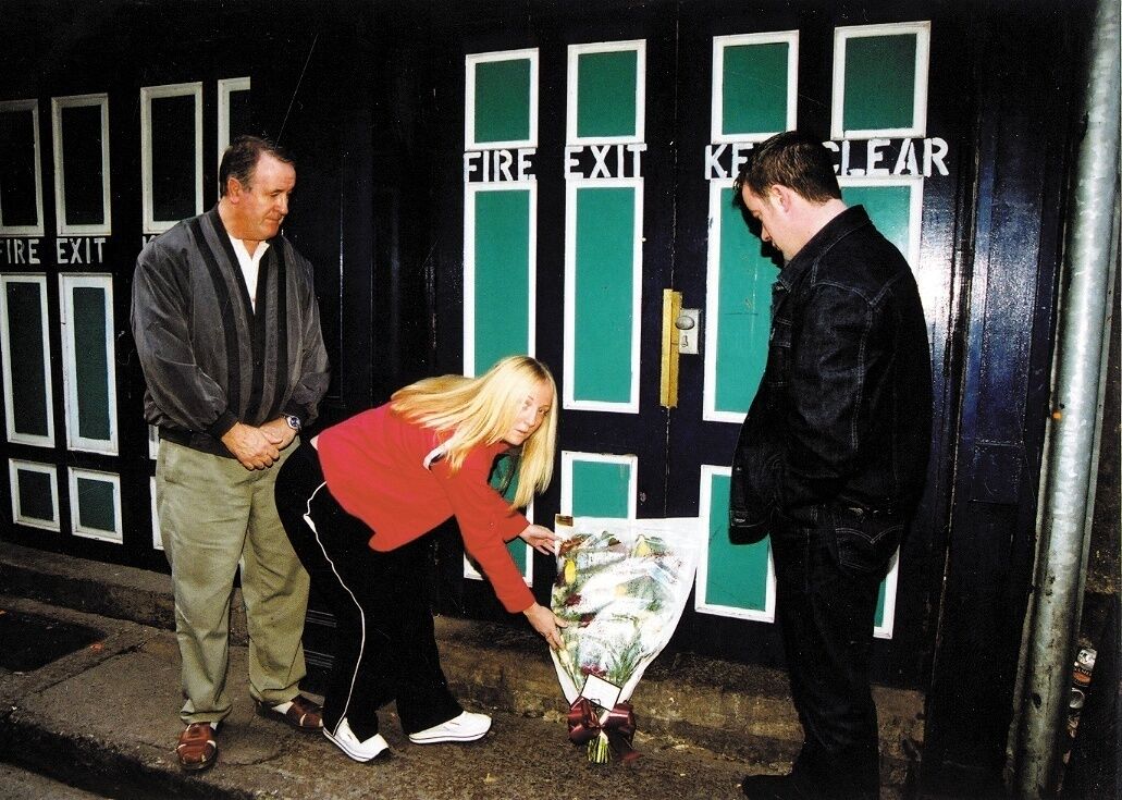 Adrian Moynihan's father Andrew, sister Audrey and brother Darren lay flowers outside Trax nightclub on the occasion of the second anniversary of his death.