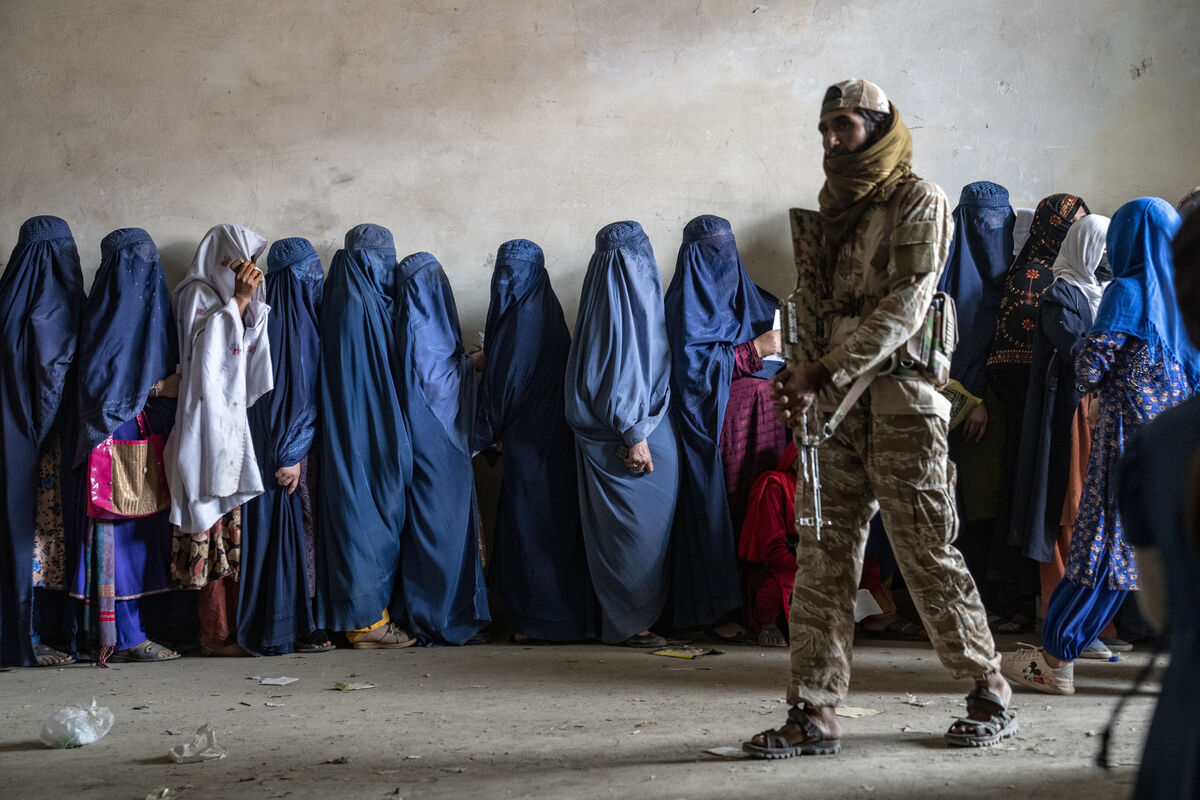 A Taliban fighter stands guard as women wait to receive food rations distributed by a humanitarian aid group, in Kabul. The Taliban had banned women from education, most jobs and public spaces like parks since seizing control of Afghanistan in 2021. Picture: AP/Ebrahim Noroozi A Taliban fighter stands guard as women wait to receive food rations distributed by a humanitarian aid group, in Kabul. The Taliban had banned women from education, most jobs and public spaces like parks since seizing control of Afghanistan in 2021. Picture: AP/Ebrahim Noroozi