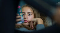 Young girl relax with her smartphone on a sofa