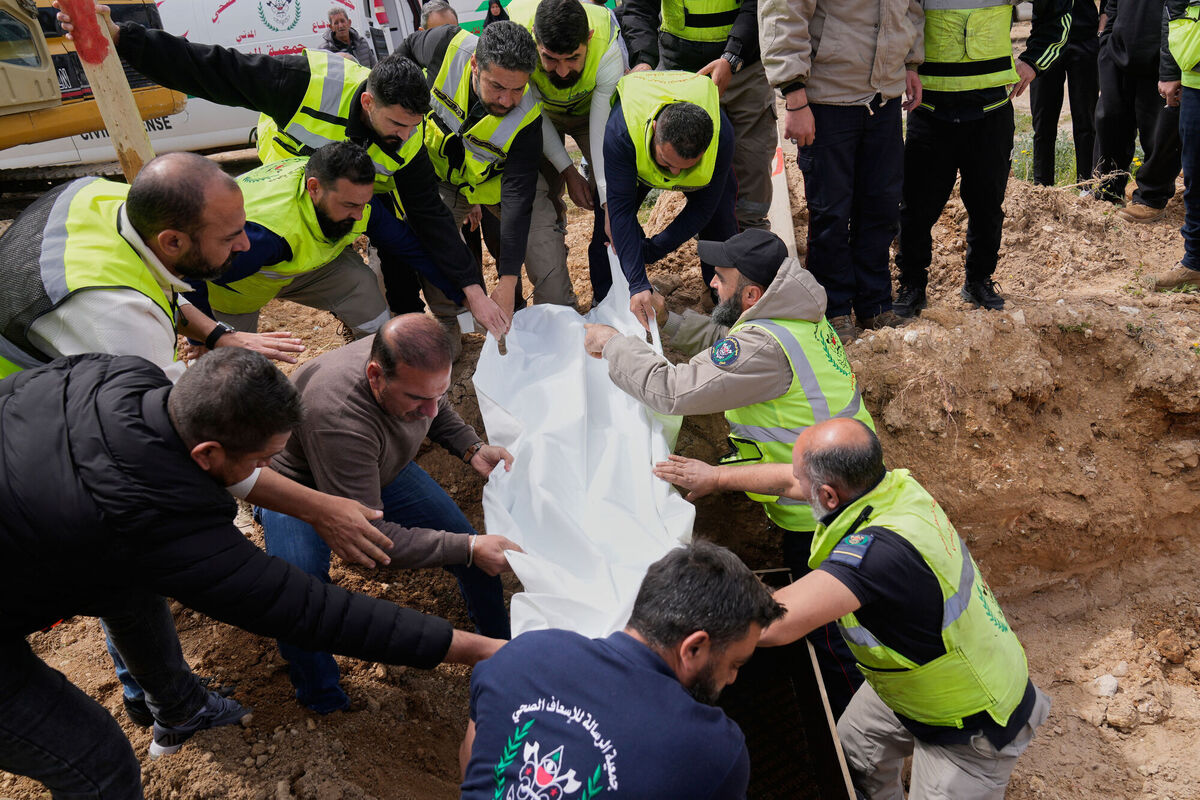 Paramedics bury the body of their comrade who was killed in an Israeli airstrike at a temporary mass grave in Tyre, south Lebanon, on Wednesday. Photo: AP/Hussein Malla Paramedics bury the body of their comrade who was killed in an Israeli airstrike at a temporary mass grave in Tyre, south Lebanon, on Wednesday. Photo: AP/Hussein Malla