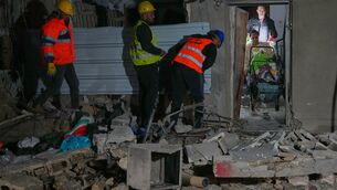 <p>Residents carry personal belongings as they leave a building damaged in a missile strike in Tel Aviv (Maya Levin/AP)</p> <p>Residents carry personal belongings as they leave a building damaged in a missile strike in Tel Aviv (Maya Levin/AP)</p>