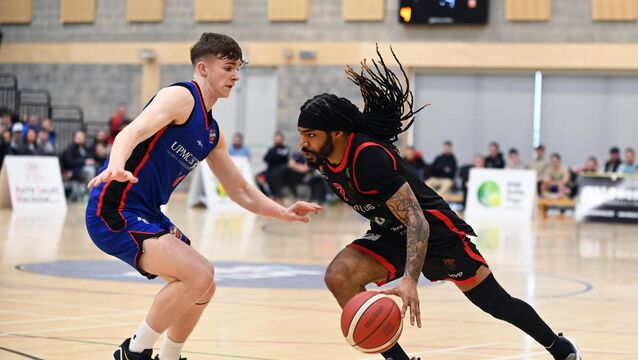 <p>Ballincollig's Latrell Jossell takes on Eanna's Adam Charles. Pic: Eddie O'Hare</p>
