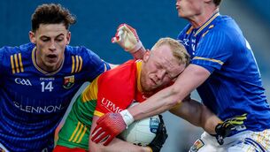 <p>Carlow's Conor Doyle is tackled by Ronan Sweeney and Joseph Hagan of Longford. Pic: Inpho</p>