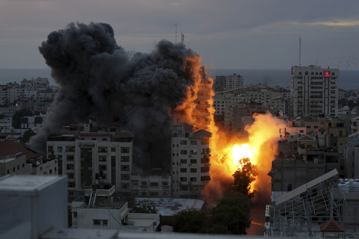 A ball of fire and smoke rise from an explosion on a Palestinian apartment tower following an Israeli air strike in Gaza City. A ball of fire and smoke rise from an explosion on a Palestinian apartment tower following an Israeli air strike in Gaza City.