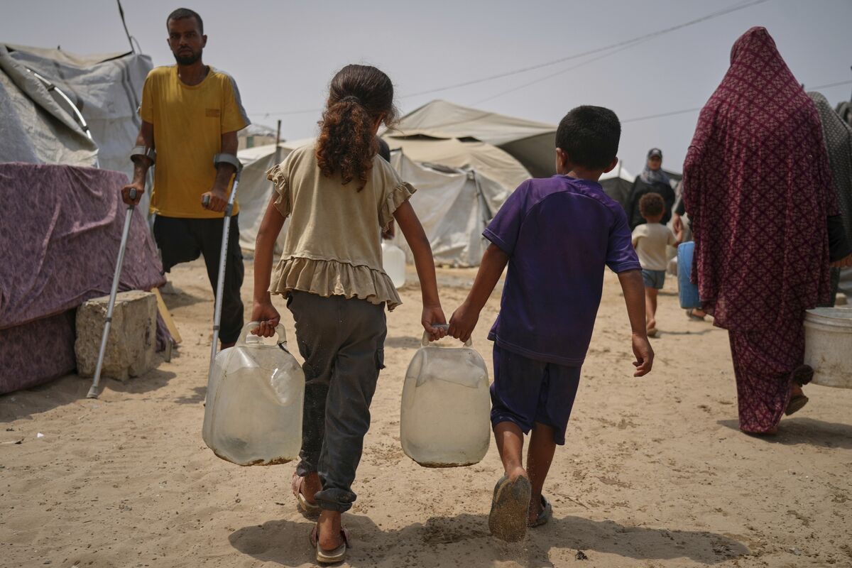 In the summer heat, Palestinian children carry jerrycans after collecting water from a distribution point in Gaza City, Tuesday, Aug. 12, 2025. (AP Photo/Jehad Alshrafi) In the summer heat, Palestinian children carry jerrycans after collecting water from a distribution point in Gaza City, Tuesday, Aug. 12, 2025. (AP Photo/Jehad Alshrafi)