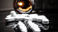 Opioids and Fentanyl: A Close-Up of Prescription Drugs and Powder on a Reflective Surface