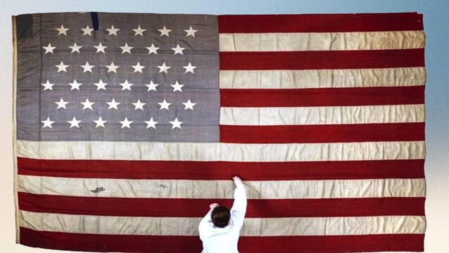 <p>Textile conservator Lorna Rowley working on the flag of the Catalpa. The National Museum of Ireland said the historic flag 'illustrates the importance of the Irish-American community and their support for Irish independence'. Picture: NMI </p>