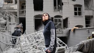 A woman looks up at the site of a strike that hit a residential building amid the US-Israeli military campaign in Tehran, Iran (Sajjad Safari/AP) A woman looks up at the site of a strike that hit a residential building amid the US-Israeli military campaign in Tehran, Iran (Sajjad Safari/AP)