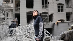 <p>A woman looks up at the site of a strike that hit a residential building amid the U.S.-Israeli military campaign in Tehran, Iran, Saturday, March 28, 2026. Picture: AP Photo/Sajjad Safari</p>