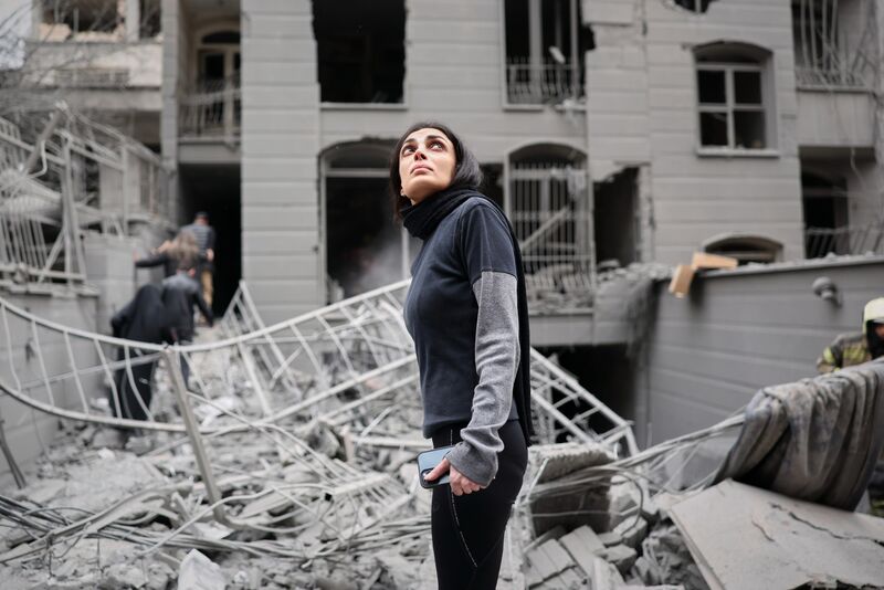 A woman looks up at the site of a strike that hit a residential building amid the U.S.-Israeli military campaign in Tehran, Iran, Saturday, March 28, 2026. Picture: AP Photo/Sajjad Safari