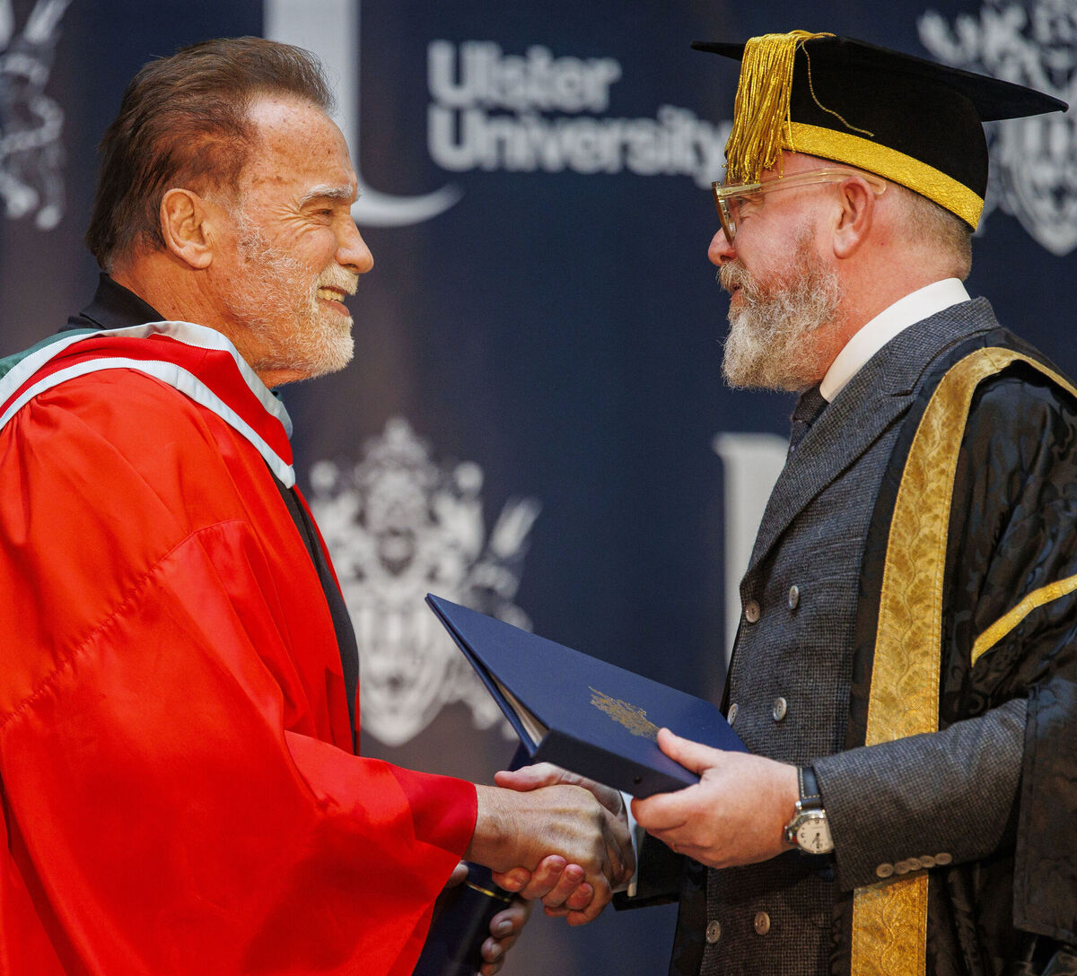 Arnold Schwarzenegger shakes the hand of chancellor of the Ulster University Colin Davidson after receiving his honorary doctorate. Picture: Liam McBurney/PA Arnold Schwarzenegger shakes the hand of chancellor of the Ulster University Colin Davidson after receiving his honorary doctorate. Picture: Liam McBurney/PA