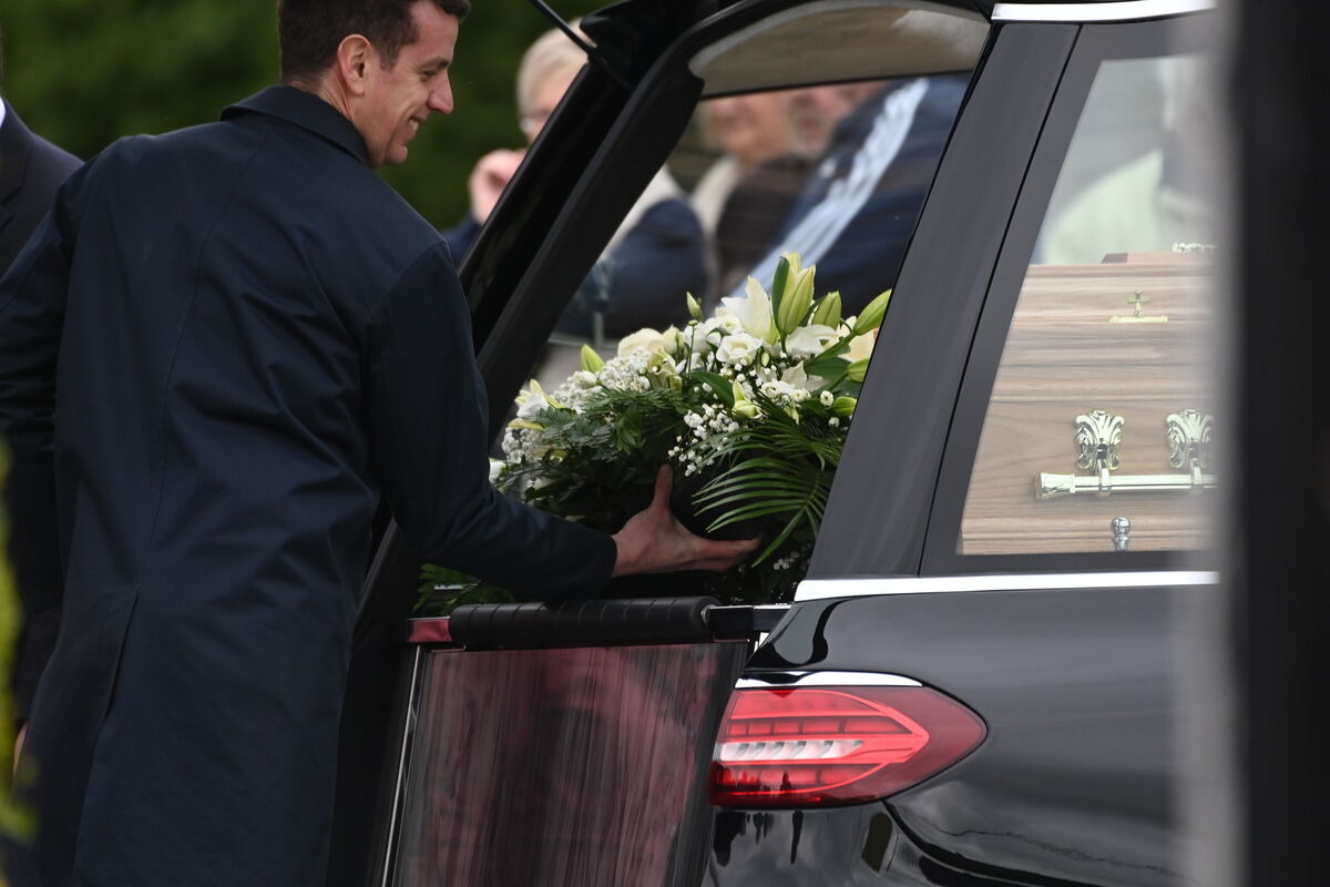  Flowers are placed in the hearse. Mourners, including Roy Keane, attending the funeral of Marie Keane at the Church of the Resurrection, Farranree, Cork. Picture: Larry Cummins