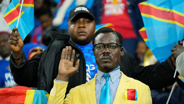 Michel Nkuka Mboladinga, a Congo DR fan impersonating late leader Patrice Lumumba, strikes a pose during an Africa Cup of Nations football match in Rabat, Morocco (Mosa’ab Elshamy/AP)