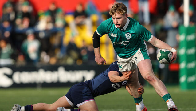 <p>Ireland's Rob Carney is tackled against Scotland. Pic: Ben Brady/Inpho</p>
