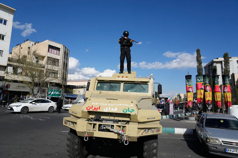 A member of police special forces stands guard on top their car at the Enqelab-e-Eslami, or Islamic Revolution, square in downtown Tehran, Iran, Monday, March 30, 2026. (AP Photo/Vahid Salemi)