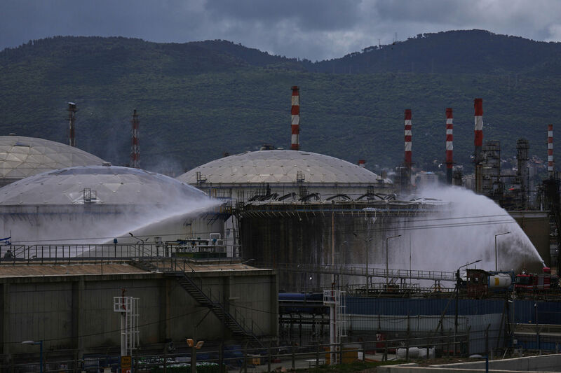 Firefighters work to extinguish a fire at the site of an Iranian missile strike in Haifa, Israel, Monday, March 30, 2026. (AP Photo/Ariel Schalit)