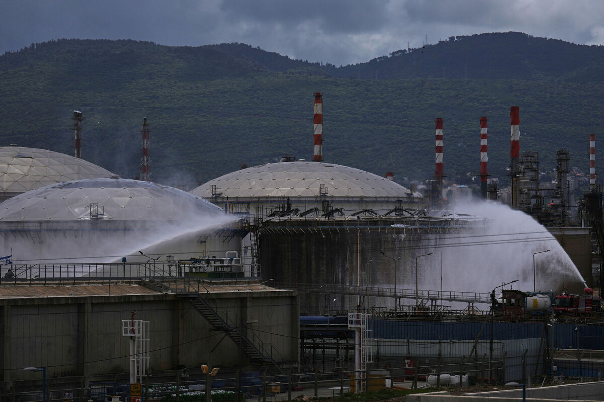 Firefighters work to extinguish a fire at the site of an Iranian missile strike in Haifa, Israel, Monday, March 30, 2026. (AP Photo/Ariel Schalit)