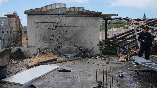 <p>Residents inspect a damaged house following an Iranian missile strike in Shefaram Israel, Monday, March 30, 2026. (AP Photo/Ariel Schalit)</p>