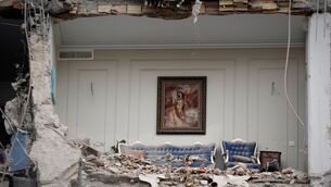 Rubble covers the furniture of a destroyed living room in a residential building in Tehran (Vahid Salemi/AP)