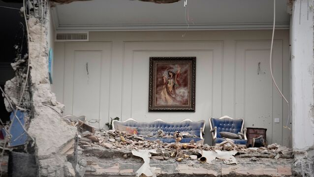 <p>Rubble covers the furniture of a destroyed living room in a residential building in Tehran (Vahid Salemi/AP)</p>