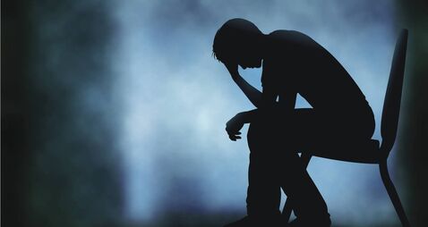 Editable vector of man on chair with head in hand