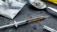 drug syringe and cooked heroin on spoon. drug addict problem and therapy concept