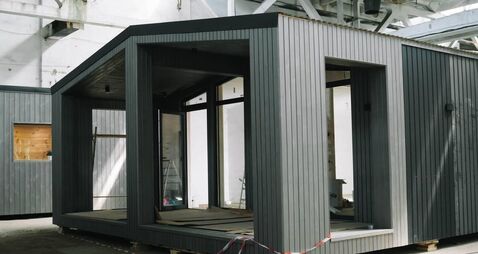 A new wooden modular prefabricated house inside in manufacturing facility