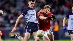 <p>Dublin's Donách Magee takes a shot despite Padraic Tinnelly of Louth. Pic: ©INPHO/Nick Elliott</p>