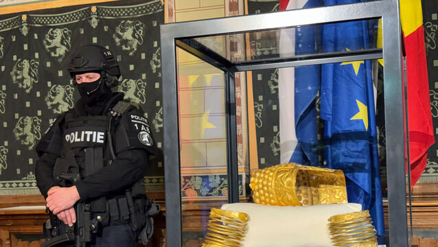 A police officer stands by the recovered helmet (Aleksandar Furtula/AP)