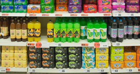 Variety of soft drinks on supermarket shelves