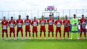 <p>Team Iran, holding photos of children killed in war, ahead of a friendly match against Costa Rica at the Titanic Mardan Palace Sports Complex in Antalya, Turkiye. Pic: Orhan Cicek/Anadolu via Getty Images</p>