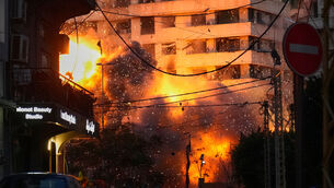 <p>An explosion erupts from a building following an Israeli strike in central Beirut, Lebanon on March 18. File picture: Hussein Malla/AP</p>