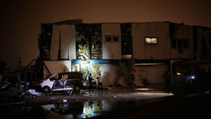 Israeli security forces and rescue teams inspect a site struck by an Iranian missile in Petah Tikva on Thursday (Ohad Zwigenberg/AP)