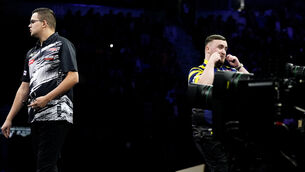 <p>Luke Littler, right, makes a crying gesture against Gian van Veen (Peter Byrne/PA)</p>