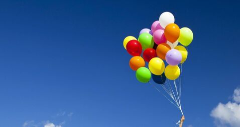 Girl with colorful balloons