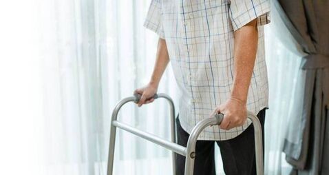 Close up hand of Asian Senior elderly disabled man patient walk slowly with walker at nursing home. Older handicapped male have