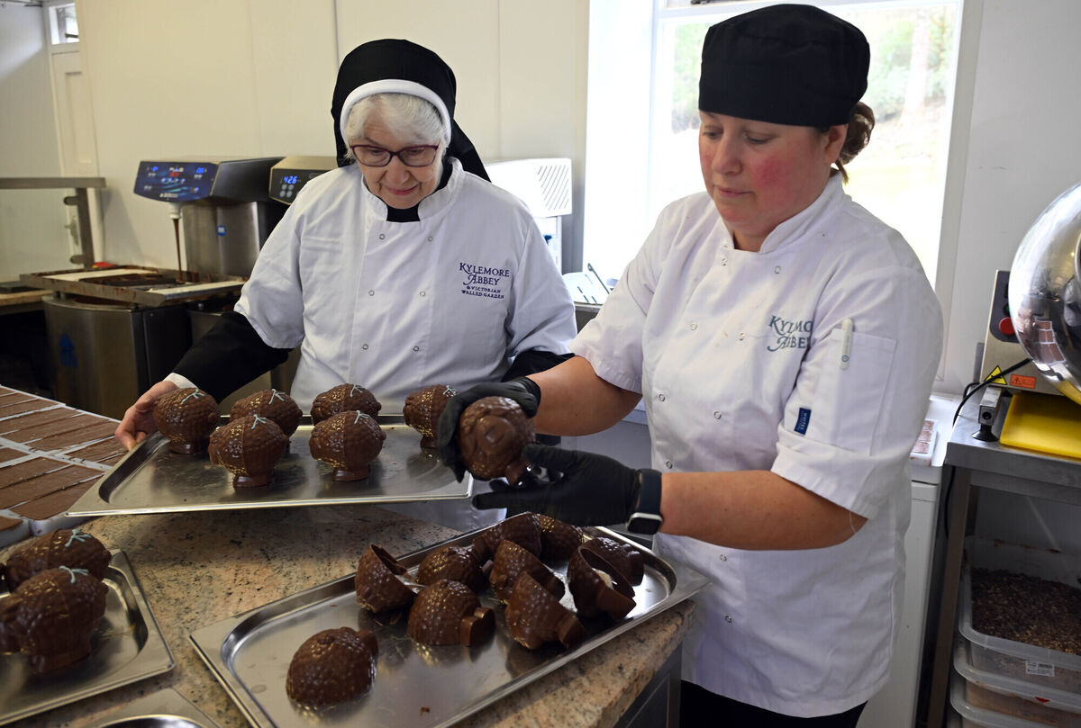 Sr Genevieve and head chocolatier Veronica Davin place a golden ticket in a chocolate Lucky Lamb.