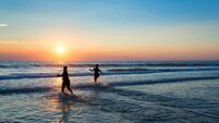Silhouettes of people enjoying the sunset on the atlantic ocean