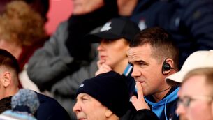 <p>WIRED FOR SOUND: Dublin’s manager Ger Brennan watches on from the stands after being red carded. Pic: INPHO/James Crombie</p>