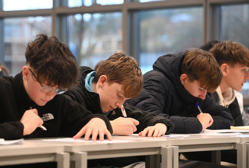 Students work out their maths problems. Students work out their maths problems.