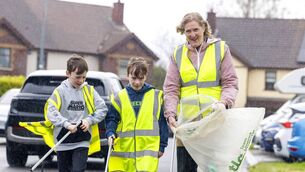 <p>Braving the rain in Glenside estate Annacotty is Helen O'Donnell with twins Ashton and Leo Mulcahy (9), for Team Limerick Clean-Up, which took place this Good Friday across Limerick. Pic Arthur Ellis</p>